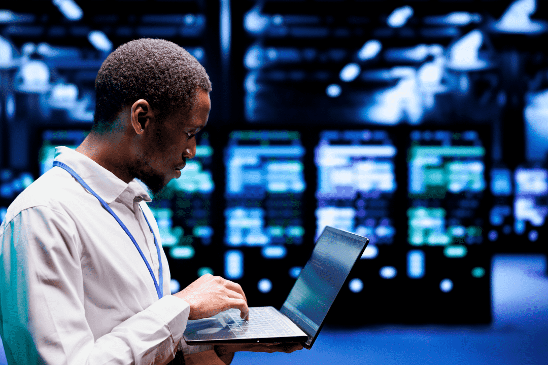 Man with laptop in a techy environment office